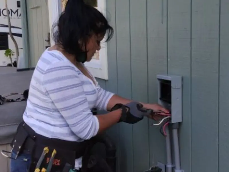 Licensed electrician wiring an exterior subpanel in Brigham City